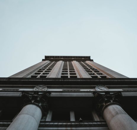 A low angle shot of a tall business building with clear blue sky in NYC